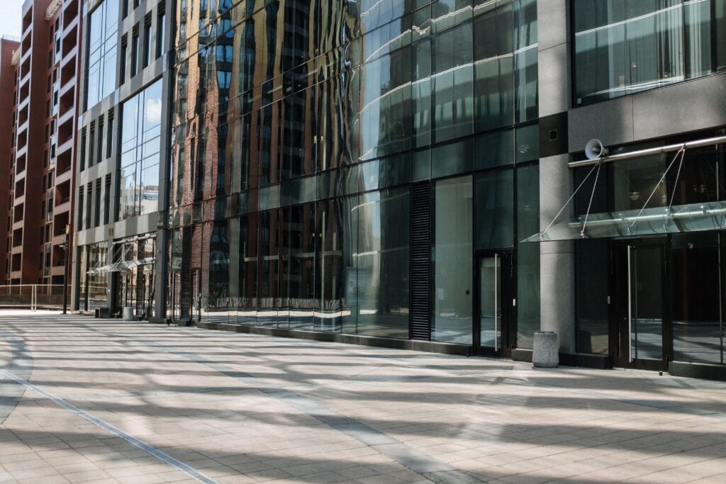 Empty cityscape featuring modern glass architecture and urban reflections.
